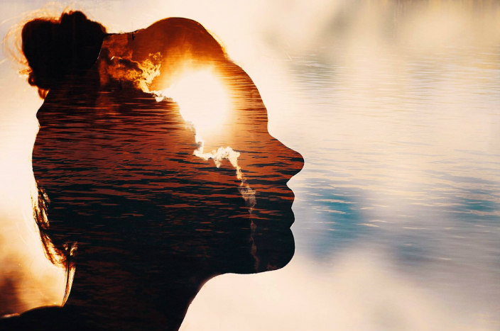 Graphic of a womans silhouette with a sunset overlaid 