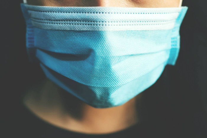 Closeup of the lower half of a persons face covered by a medical mask