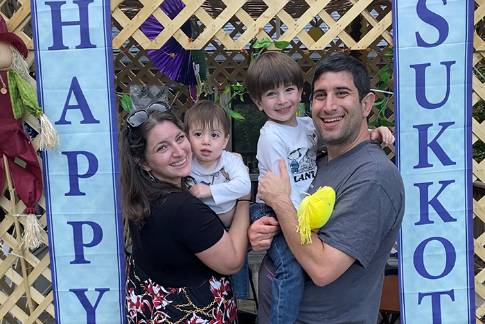Cantor Lauren Phillips Fogelman and family in their sukkah