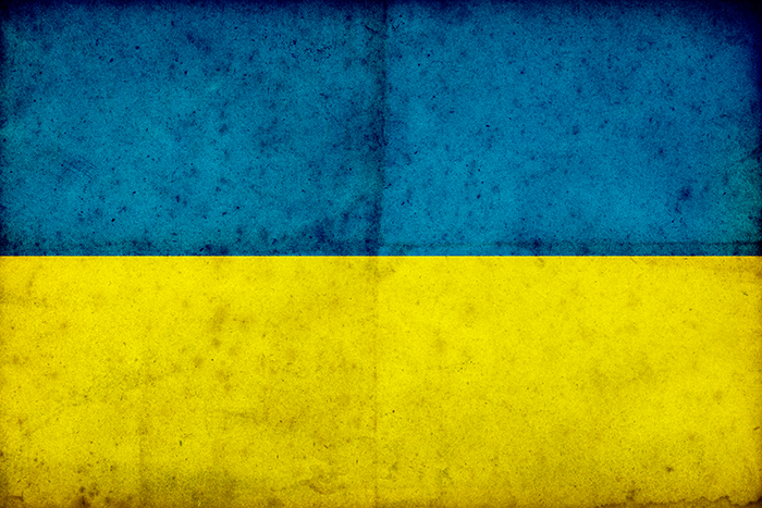 Grunge Ukraine Flag on rough edged old postcard