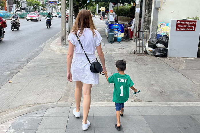 an image of Laura Frank and her son Toby walking down the sidewalk