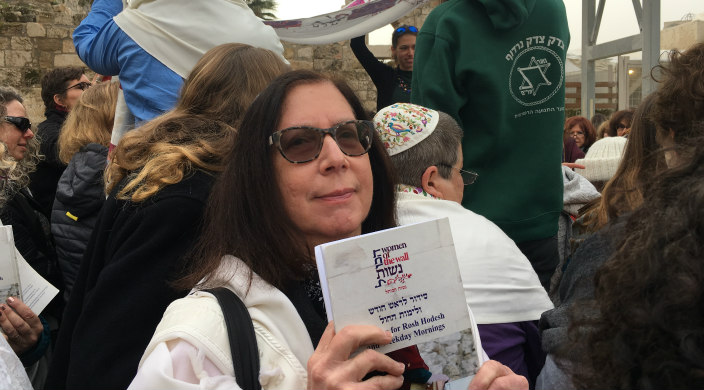 Frieda Hershman Huberman, the author, holding a prayer book at the Kotel