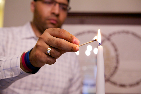 Person lighting a candle