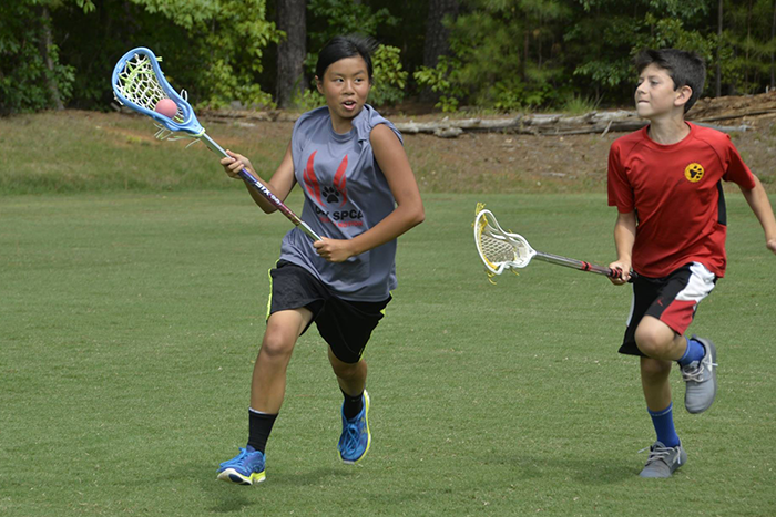 Campers playing lacrosse at Six Points Sports Academy