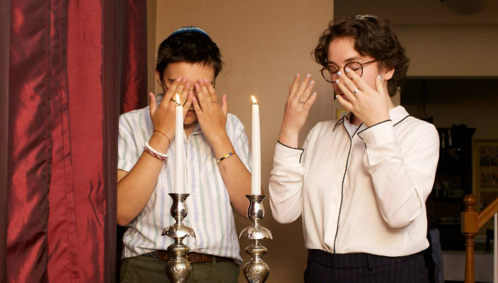 Jewish couple blessing the candles