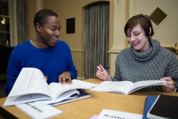 two people studying and smiling in an Introduction to Judaism class