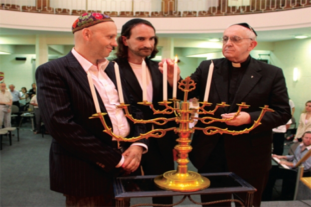 Rabbi Sergio Bergman (left, today member of Argentinian<BR> Parliament), Rabbi Alejandro Avruj, and Cardinal Jorge<BR> Bergoglio (today Pope Francis) light Hanukkah candles<BR> in NCI-Emanu El Congregation, 2012.