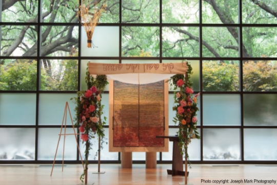 Ornate floral chuppah in an empty room