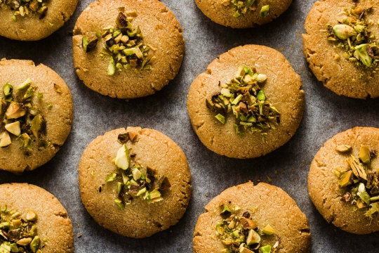 Aerial view of small cookies topped with pistachios