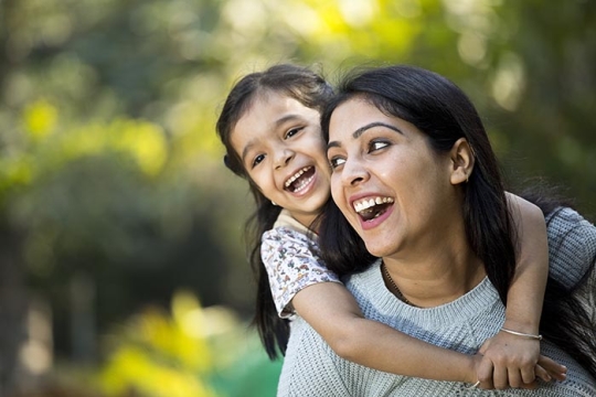 child hugging parent and smiling