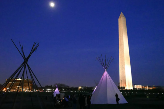 an image of a teepee in front of the Washington monument in Washington DC