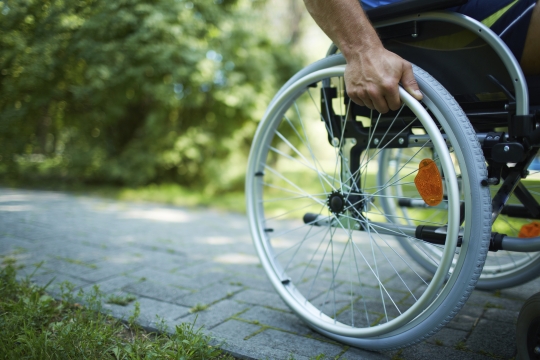 A wheelchair on a paved walkway