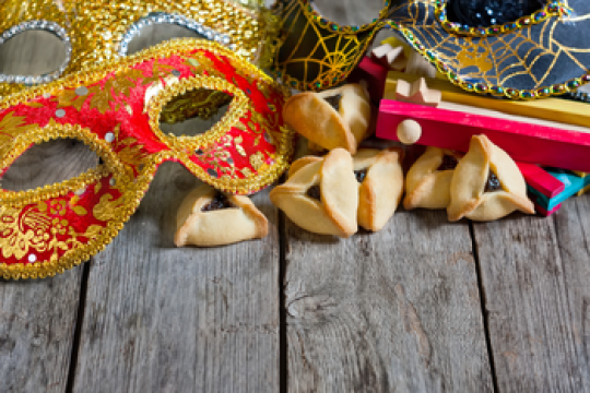 An assortment of decorations, from masks to hamantaschen to groggers, used to celebrate the Jewish holiday of Purim