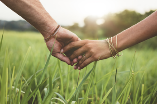 an interfaith couple holding hands