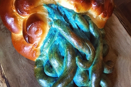 Challah with blue strands of "water" flowing from it.